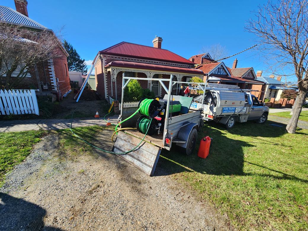 Luke Taylor Plumbing's ute and water jetting trailer on a job in Bathurst